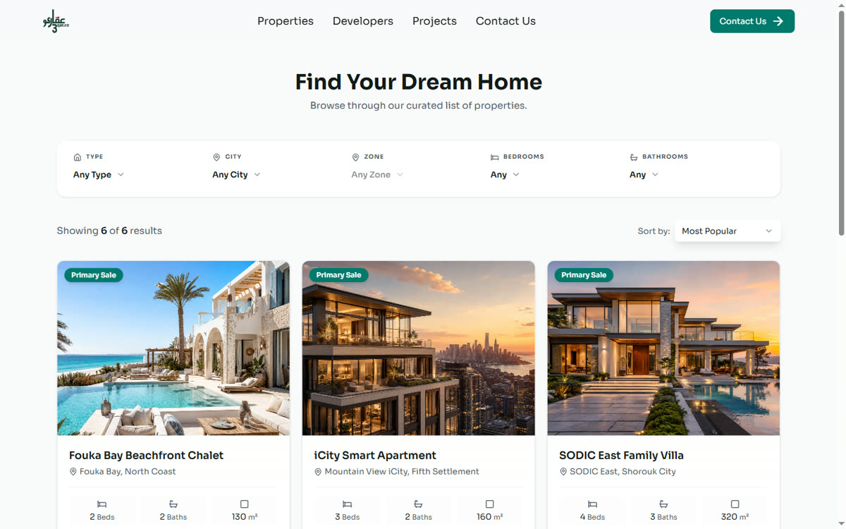 3qar.co property listing grid with real units, shown on a laptop screen
